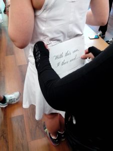 Pinning on Kimberly's per-marriage race bib. 